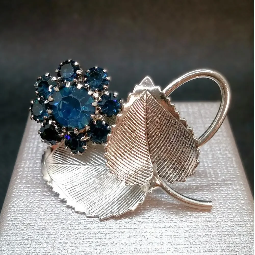 Vintage Silver Tone Flower Brooch Blue Rhinestones Prong Setting Textured Leaves